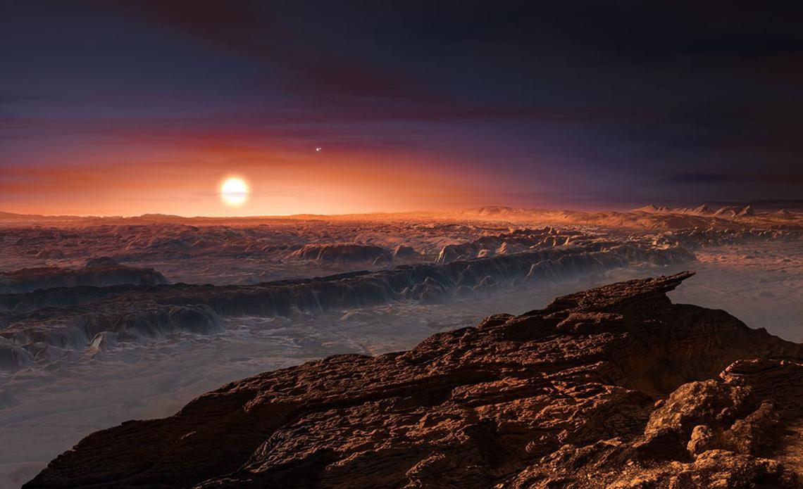 This artist’s impression shows a view of the surface of Proxima b orbiting the red dwarf star Proxima Centauri. Because the planet orbits just 4.7 million miles (7.5 million km) from its parent star, it's probably "tidally locked", with one hemisphere permanently facing the star and the other in complete darkness. (ESO / M. Kornmesser)